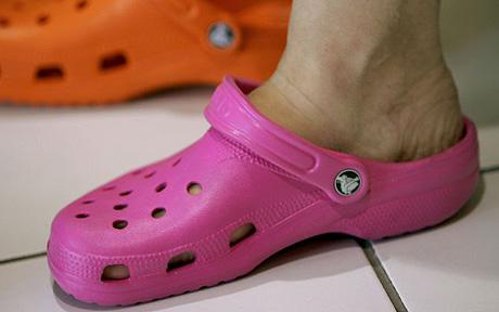 Crocs Shoes Increasingly Popular Amongst Trendy Israelis...RAMAT HASHARON, ISRAEL - JUNE 23: An Israeli woman shops for Crocs to replace her old sandals in a shoe store June 23, 2006 in the upscale Ramat Hasharon town north of Tel Aviv, Israel. The trendy shoes are becoming increasingly popular amongst Israelis willing to pay about $45 for the lightweight, colorful resin shoes. The American company sold 6 million pairs of its various designs last year, about 4,000 times the company's sales of 1,500 pairs when it was founded in 2002. (Photo by David Silverman/Getty Images)