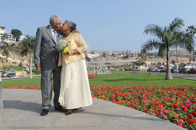Older dressed up couple, kissing