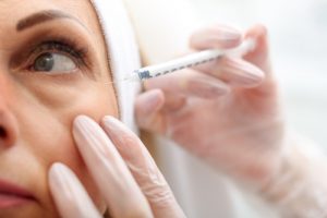 why is my eye twitching-a woman receives a botox injection below her left eye