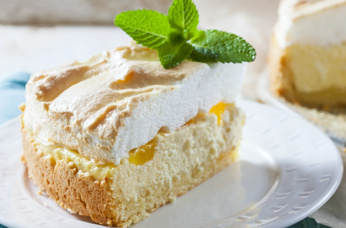 Lemon Meringue Cheesecake with garnish on a white plate