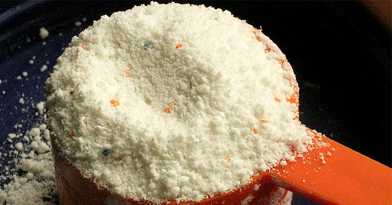 A cup of powder form laundry detergent