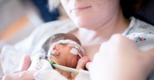 Mothers Who Give Birth to Premature Babies—What Life Is Like in the NICU NICU mom hold intubated baby