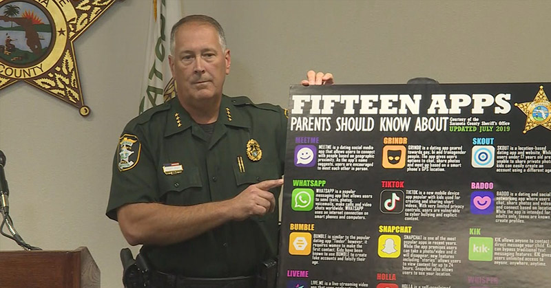policeman holding board showing 15 apps that parents should know about