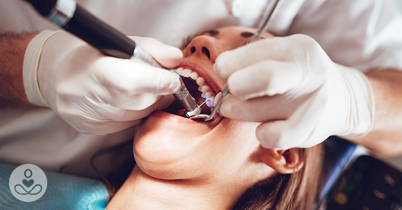 dentist working on female patients teeth