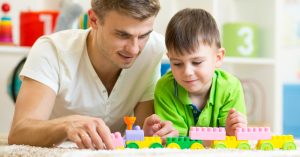 Simple Toys May Be The Best Kind For Your Child’s Development parent playing with child
