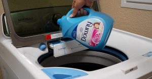 downy being poured into washing machine