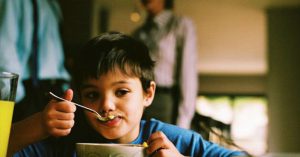 Toxic Marriages Are More Painful For Kids Than Divorce child eating bowl of cereal