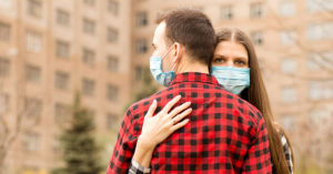 man hugging woman
