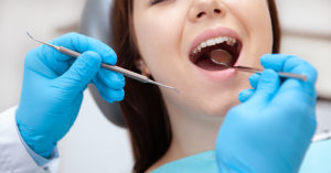 New dental treatment can stop tooth decay with one drop, no drilling required woman at dentist