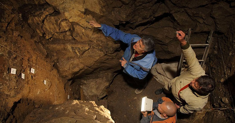 archeologists in cave