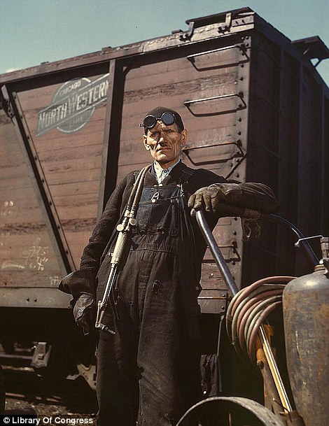 April 1943: Welder Mike Evans by the rip tracks at the Proviso yard of the Chicago and Northwest Railway Company in Chicago, Illinois