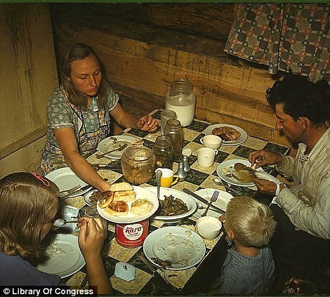 October 1940: The Faro Caudill family having dinner in their dugout home in Pie Town