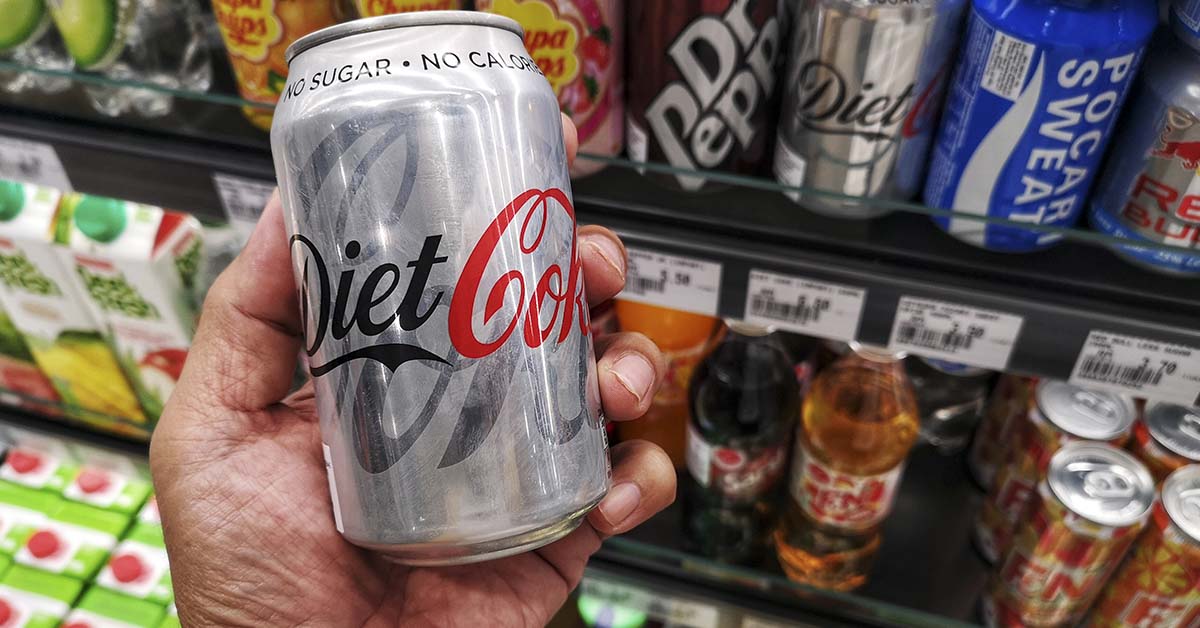 hand holding a can of diet coke