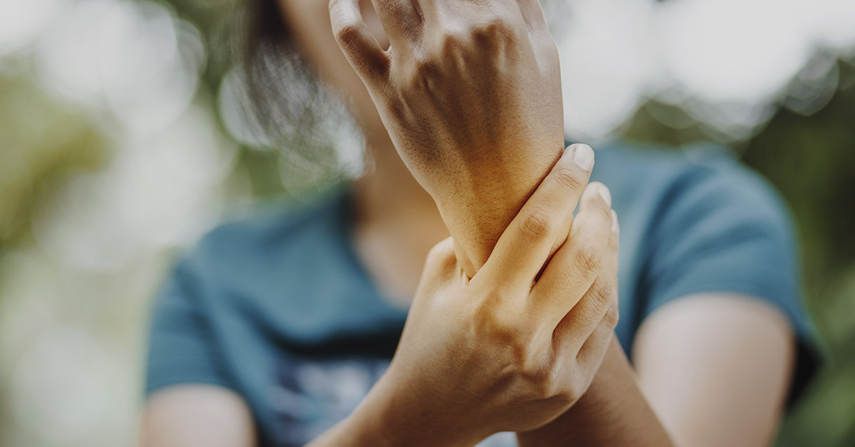 woman holding wrist in pain