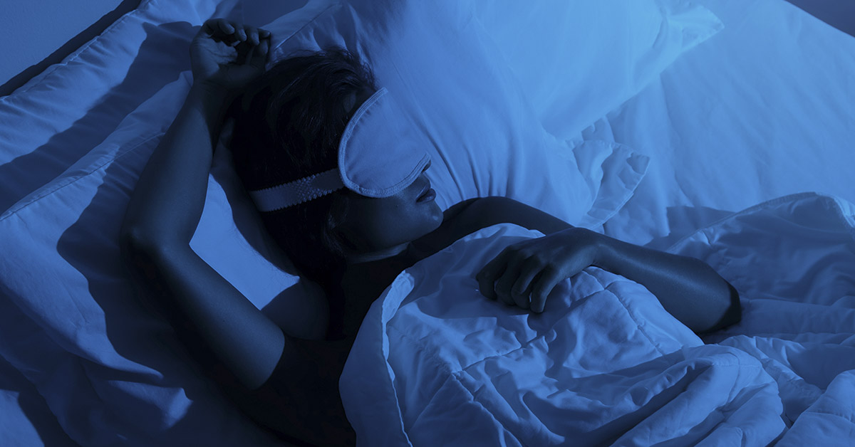 person sleeping in middle of the night wearing face mask