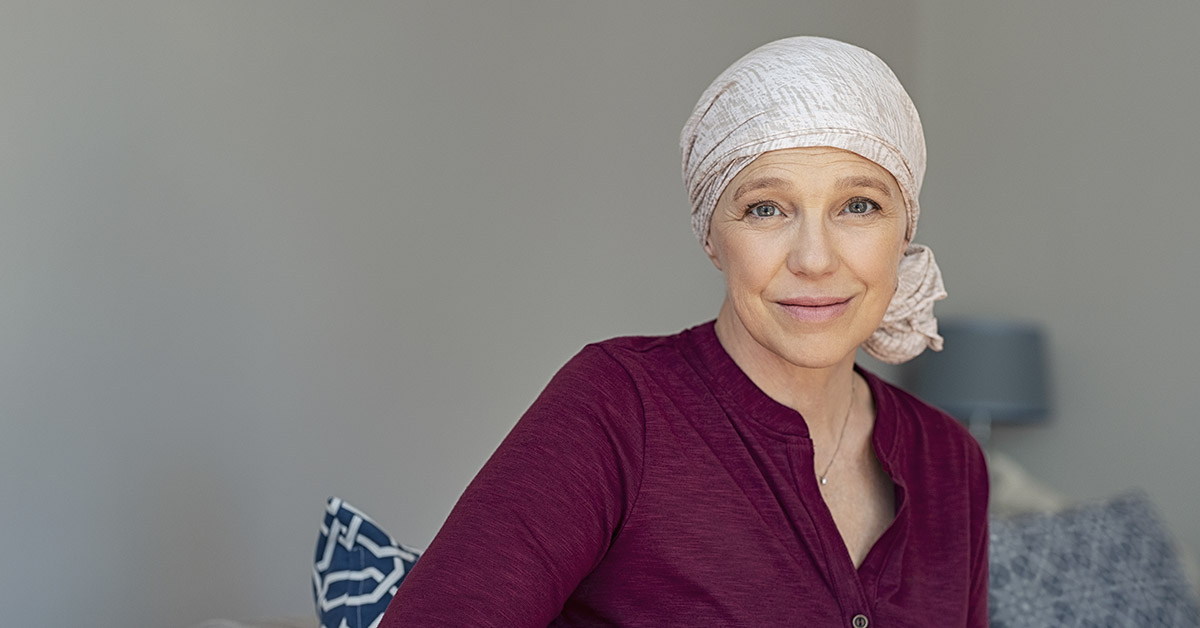 female cancer patient wearing white headband due to hair loss