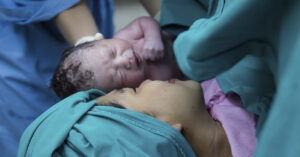 Why Women Don't Lick Their Babies Clean After Childbirth mother with new born being placed on her after delivery
