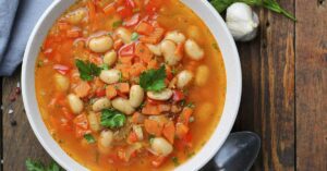 soup containing white beans and carrots