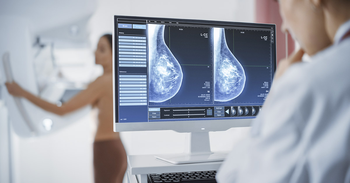 doctor looking at screen with mammogram images