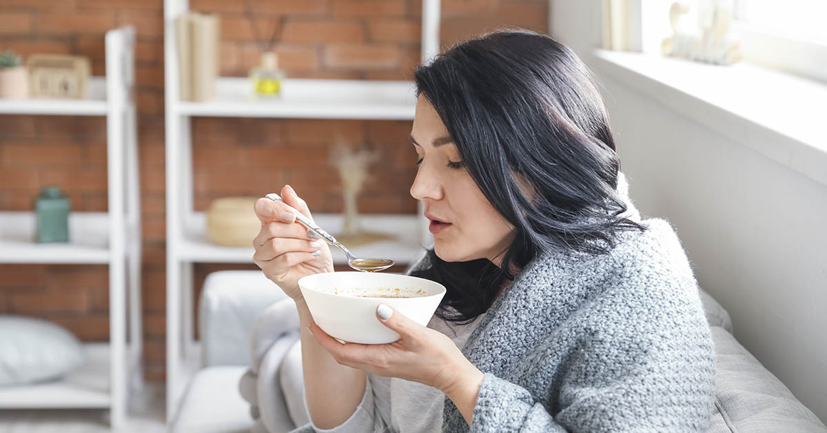 woman eating chicken soup