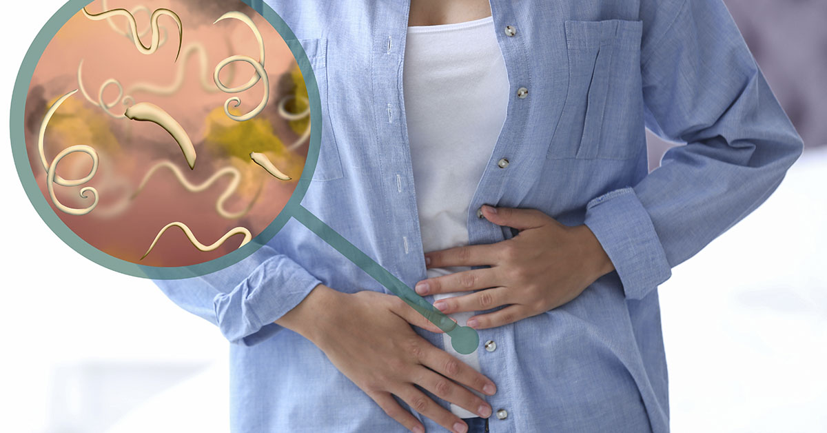 person holding abdomen depiction of someone with intestinal parasites