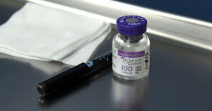 Breakthrough Reveals How Botox Infiltrates Brain Cells vile of botox with needle on stainless steel surface. medical setting