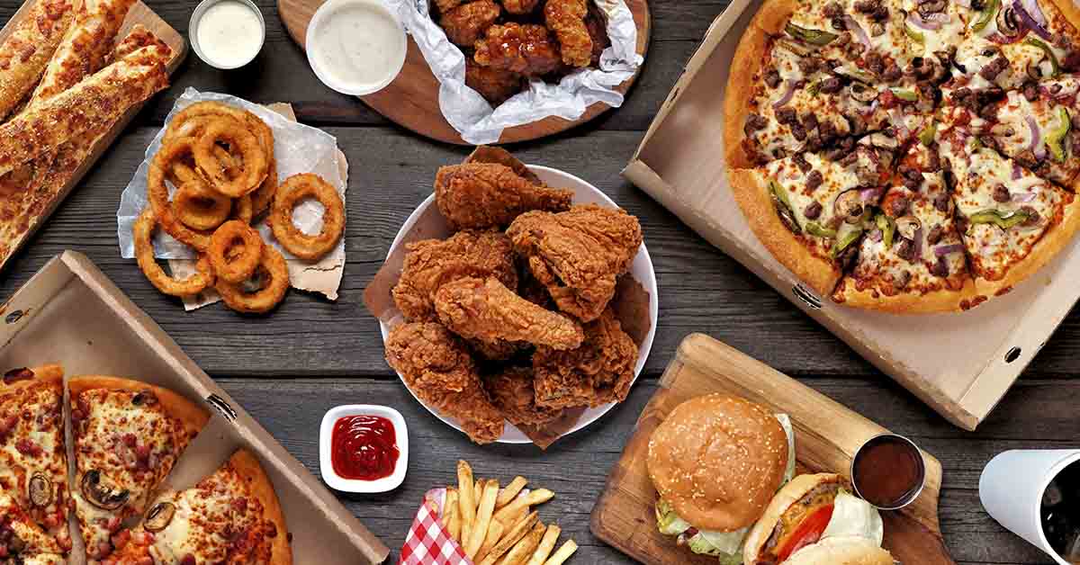 various fast food items. Pizza, fried chicken, onion rings, french fries, etc.