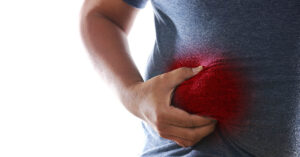 man holding side of abdomen near liver. Fatty liver disease concept