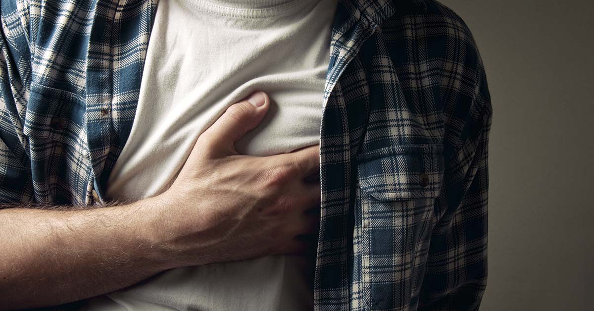 man with heart placed over chest