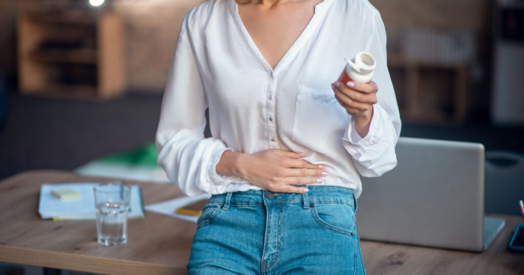 woman with hand on stomach