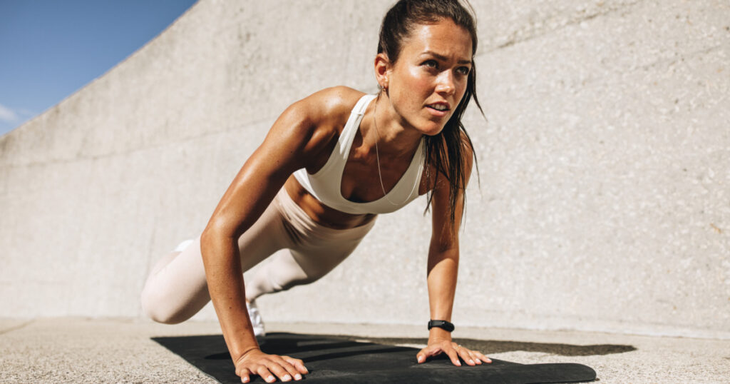 Fitness woman doing wide mountain climbers exercise