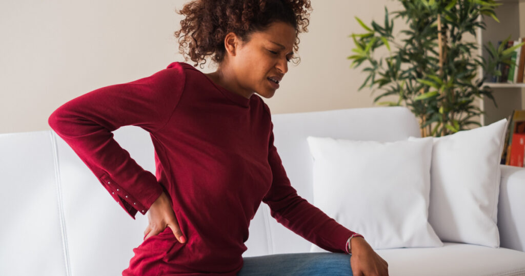 Young black woman suffer back pain cramp