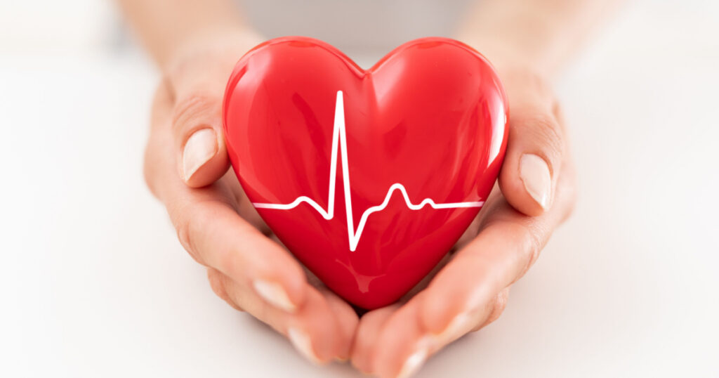 woman is holding a red heart