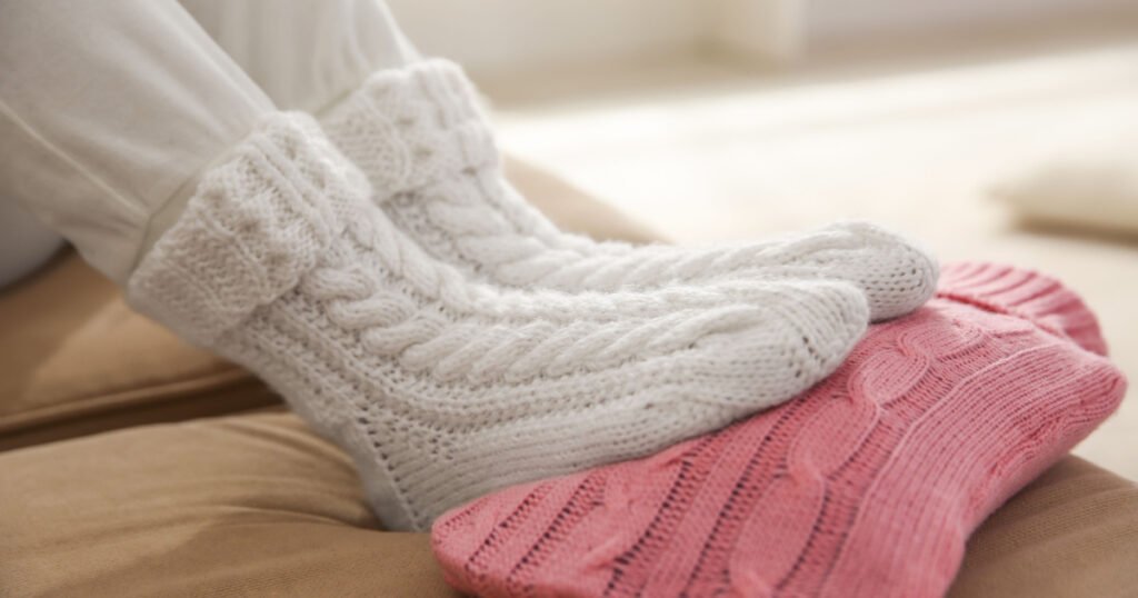 warming feet on hot-water bottle for toe cramps
