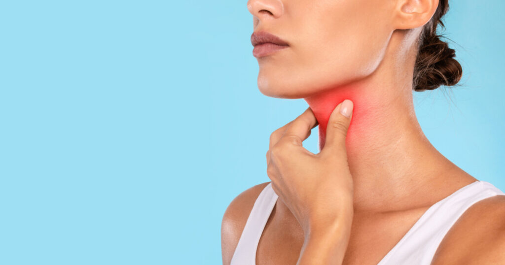 lady touching neck with hand, inflamed red zone