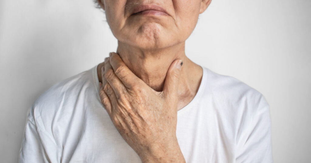 Man with sore throat from acid reflux