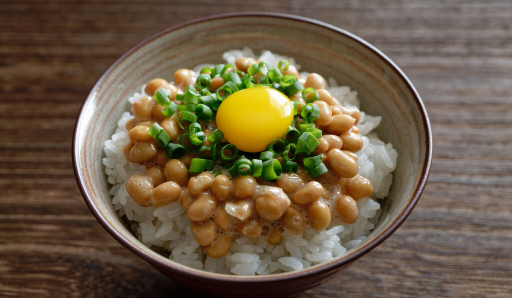 Nattoo with an egg yolk served on rice in a bowl 