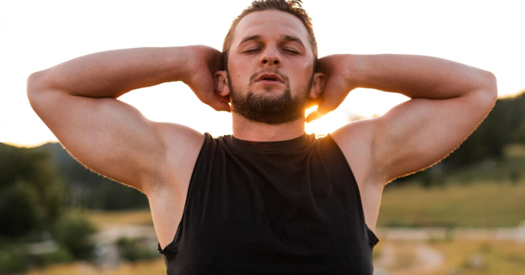 A young sporty man is relaxing with eyes closed after exercise or workout active healthy lifestyle. 