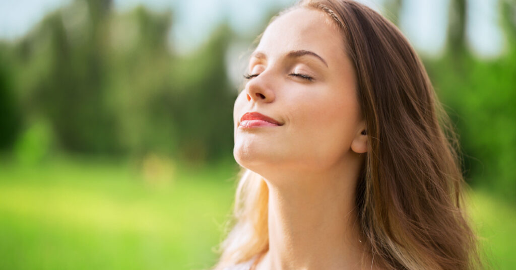 woman breathing in fresh air