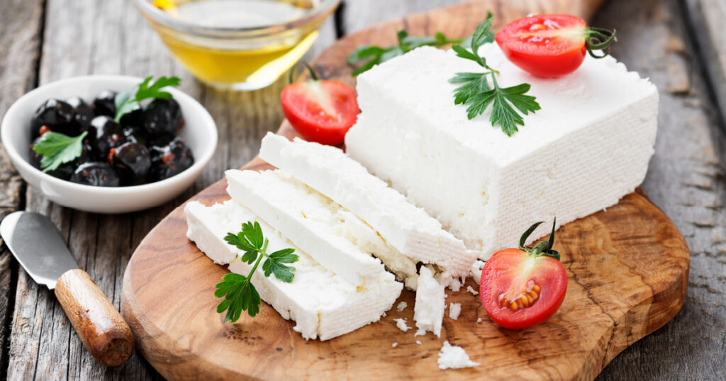 Sliced Feta cheese with herbs and olive oil.
