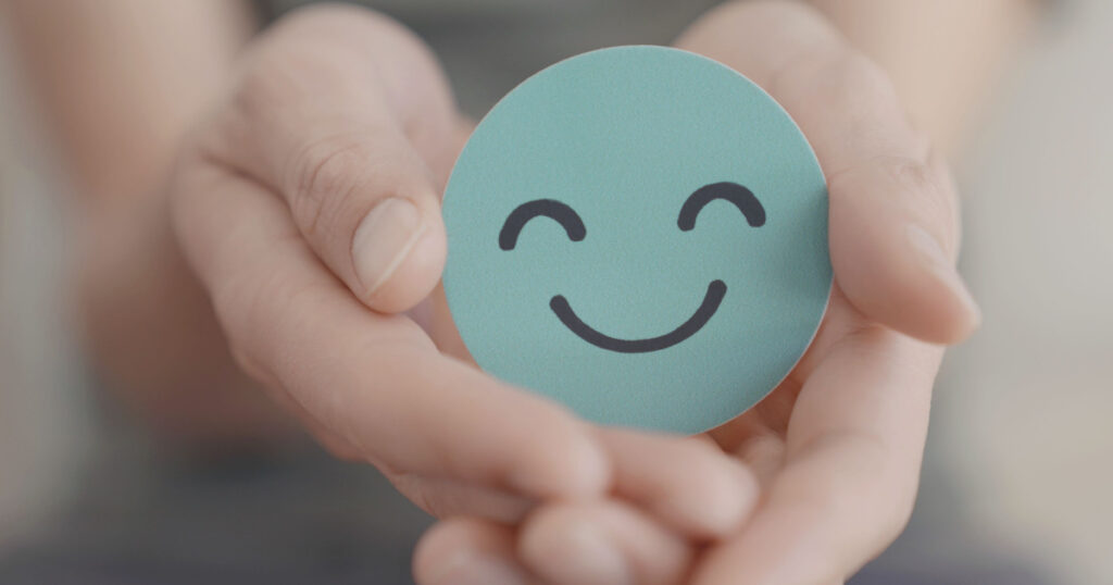 Hands holding green happy smile face, good feedback rating and positive customer review,experience, satisfaction survey,mental health assessment,child feeling good,world mental health day, Compliment
