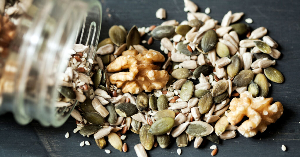 Various seeds , nuts seeds , pumpkin seeds and varies in glass jar
