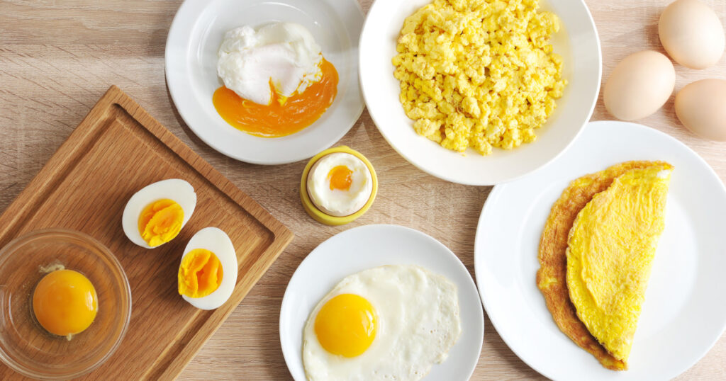 Various ways of cooking weight loss foods eggs. Omelette, poached, soft-boiled, hard-boiled, fried, scrambled eggs. Top view. Close-up.