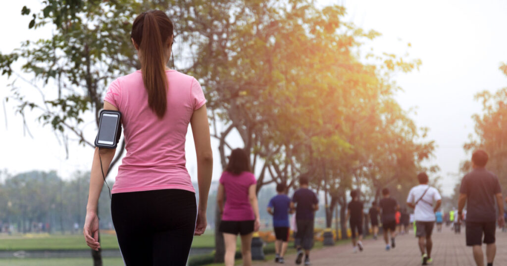 Group of people exercise walking in the park in morning
