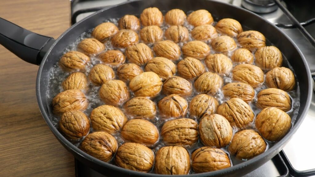 whole walnuts boiling in pan 