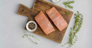 World’s First 3D-Printed Vegan Salmon Arrives in Grocery Stores – Here’s What You Should Know. salmon fillets on a cutting board