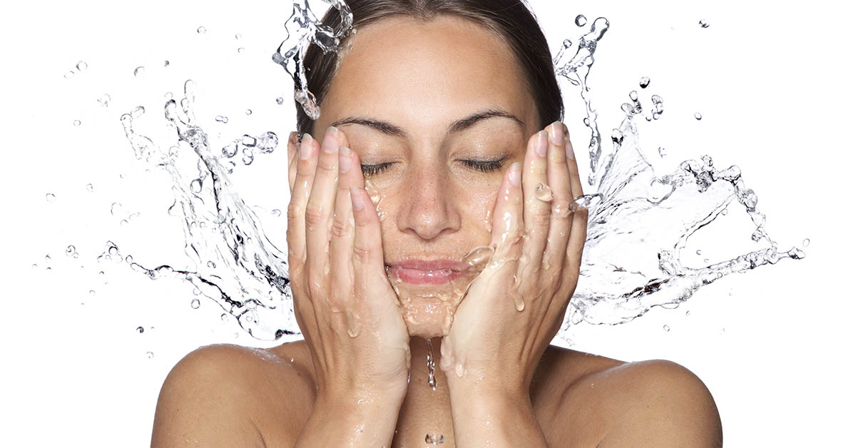 woman splashing water on face