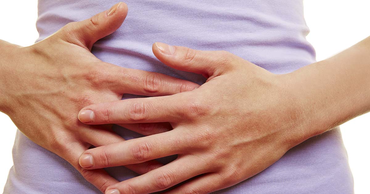 person placing hands over abdomen