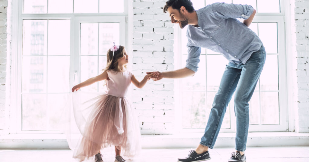 girl dancing with her dad