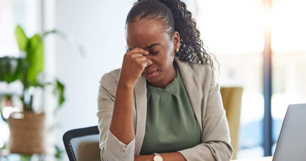 Crisis, stress and black woman with problem in office, sick or headache from brain fog. Frustrated, fatigue and African professional with business fail, mistake emoji or debt, bankruptcy or tax audit
